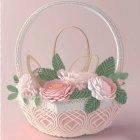 White Wicker Basket with Pink and White Paper Flowers on Pink Background