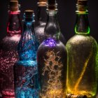 Five ornate glass bottles with intricate floral designs casting colorful reflections