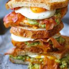 Tasty bacon and egg sandwich with melted cheese