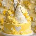 Yellow and White Floral Wedding Cake with Bride and Groom Topper