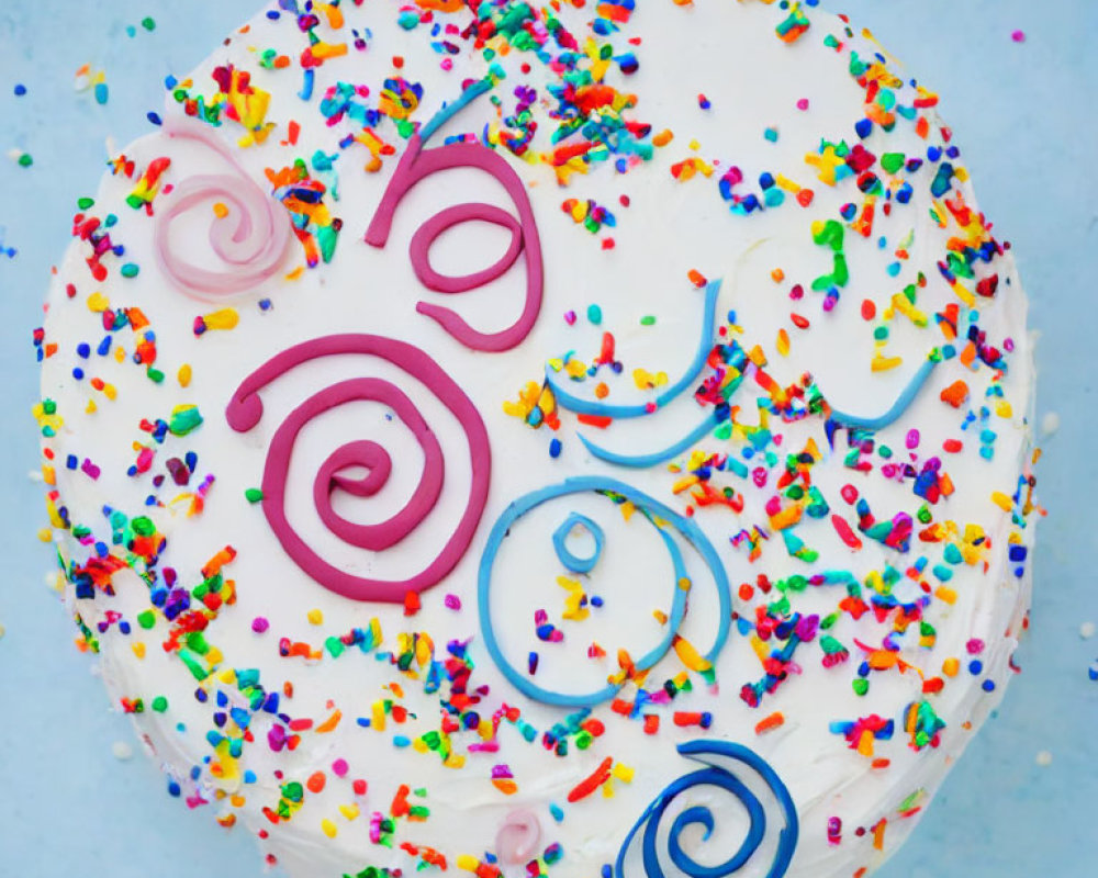 Colorful Sprinkle Frosted Cake with Pink and Blue Icing Swirls