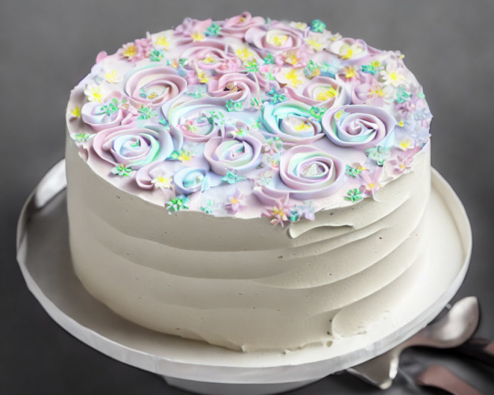 Pastel-colored rose-shaped icing on frosted cake with flower decorations