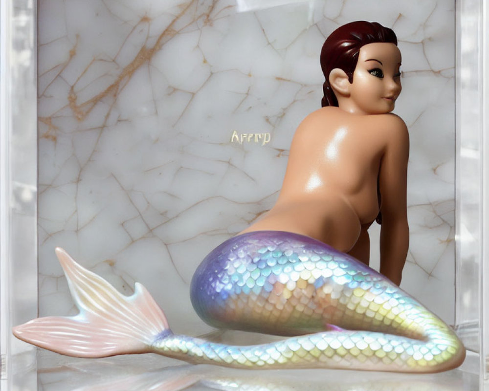 Colorful Mermaid Figurine Against Marble Background