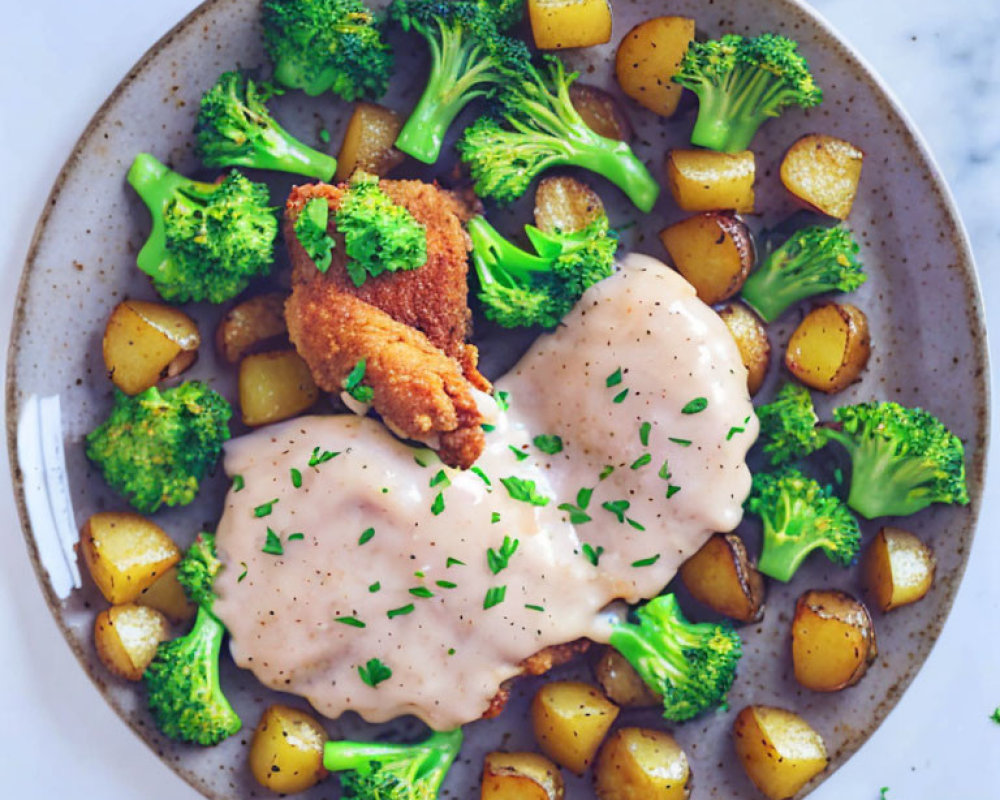 Breaded Chicken with Creamy Sauce, Roasted Potatoes, Broccoli & Herbs