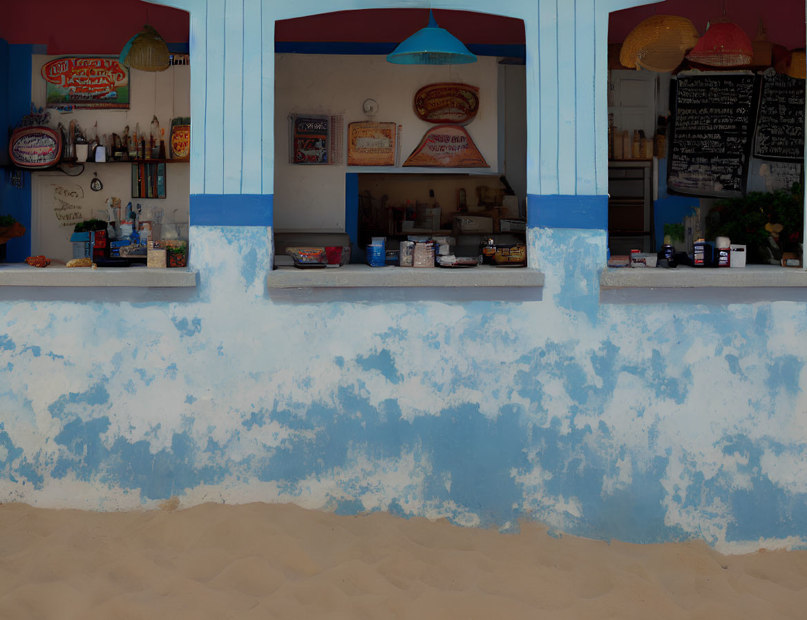 Vibrant beachside snack bar with blue facade and menu board