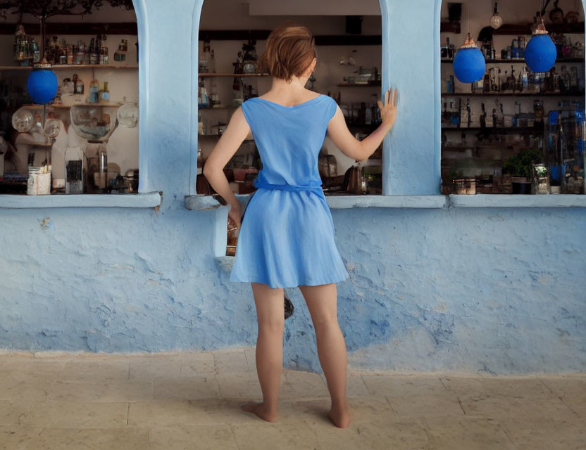 Woman in Blue Dress at Bar Counter with Blue Decor