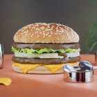 Giant Burger with Lettuce and Cheese on Martian Landscape with Robotic Equipment and Eggs