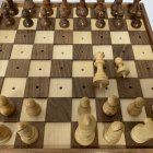 Space-themed chessboard with fantasy figures held by person