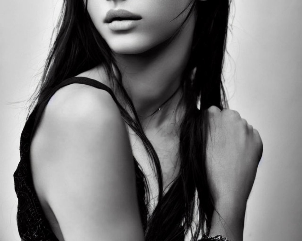 Monochrome portrait: Woman with long hair, dark dress, and bracelet