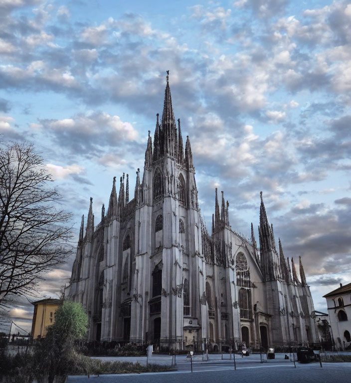 Gothic Cathedral with Spires and Cloudy Sky in Empty Square