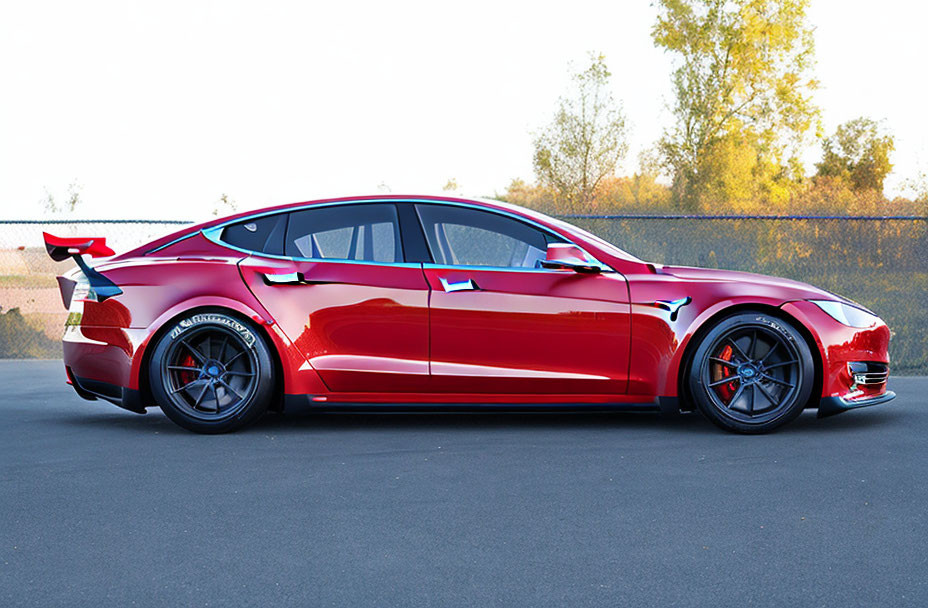 Vibrant red sports sedan with aftermarket modifications on asphalt road