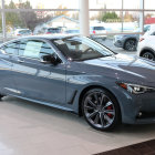 Metallic Gray Sports Coupe with Custom Blue Detailing and Aftermarket Wheels in Garage