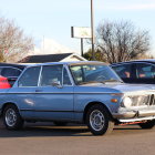 Classic Blue and White BMW Race Car Among Vintage Cars at Car Show