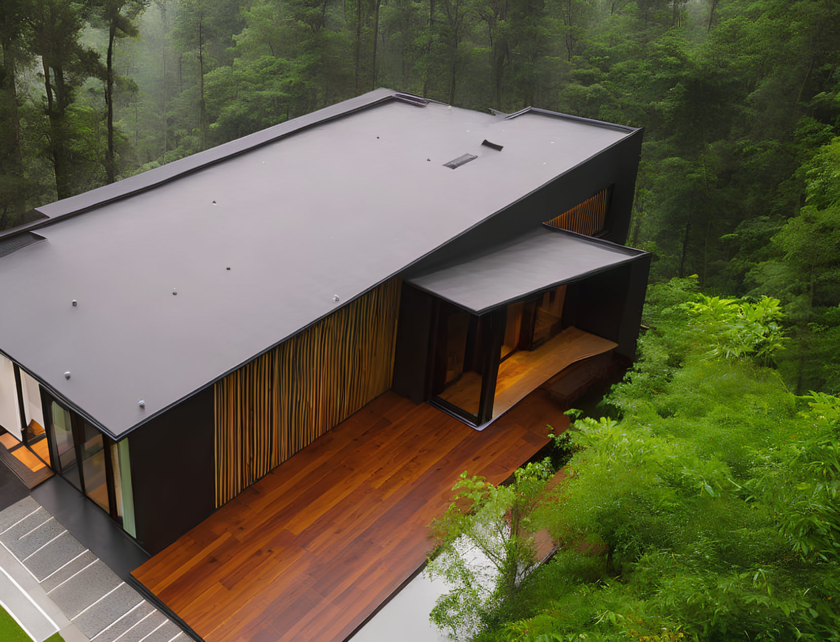 Contemporary house with dark roof and wooden details in misty green forest