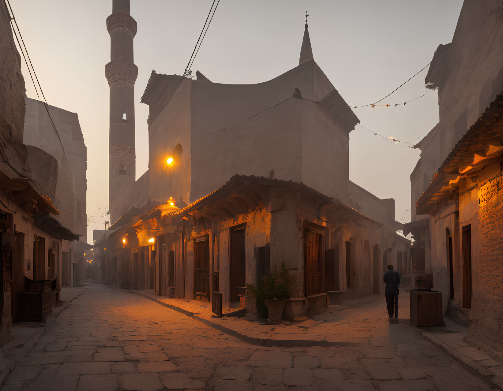 Historic architecture and minaret in tranquil street scene at dawn or dusk