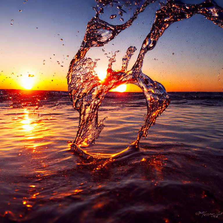 Vibrant sunset beach scene with water splash and glittering arc