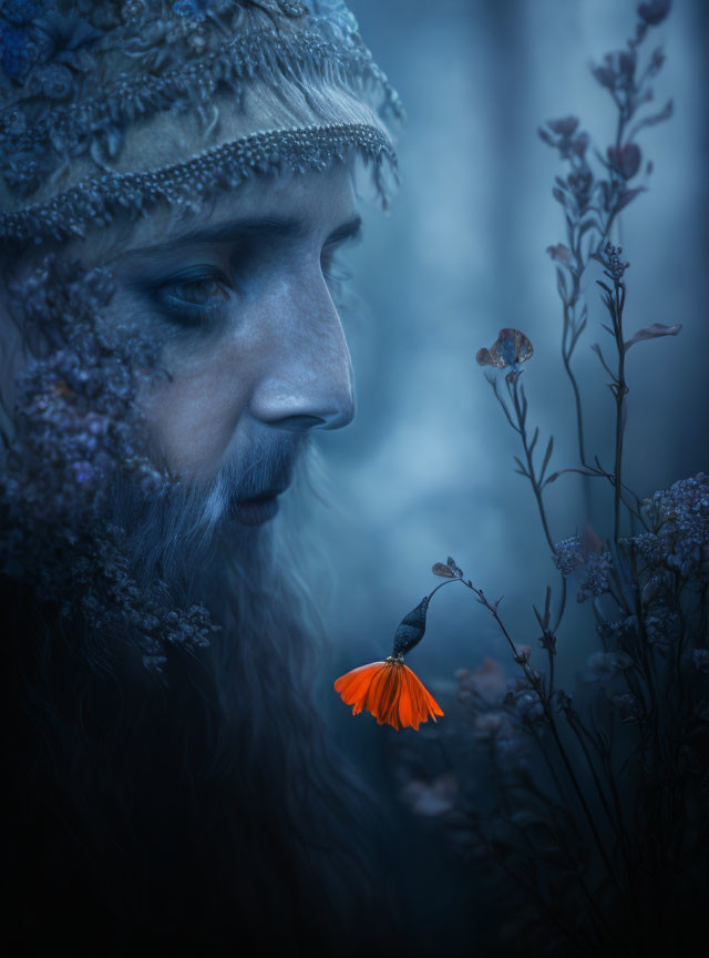 Bearded figure with jeweled headpiece admires orange flower in mystical forest