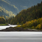 Misty river landscape with lush forests and rolling hills