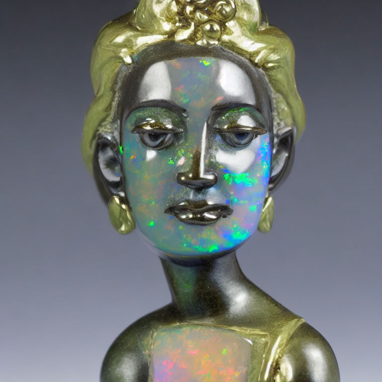 Reflective iridescent statue with gold accents and serene face wearing traditional earrings and headpiece