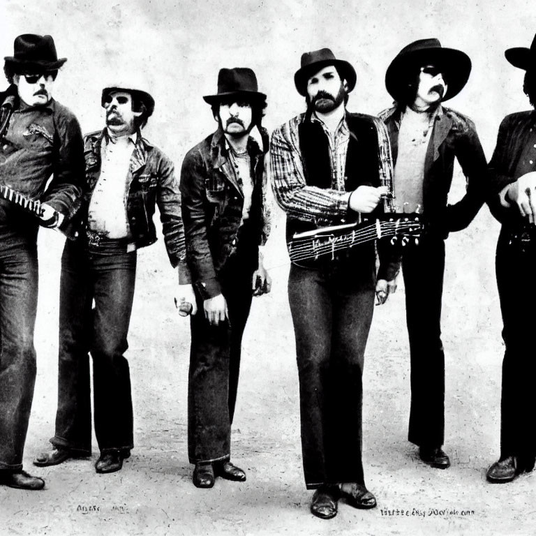 Vintage Attired Men with Hats and Mustaches Posing Confidently in Monochrome Photo