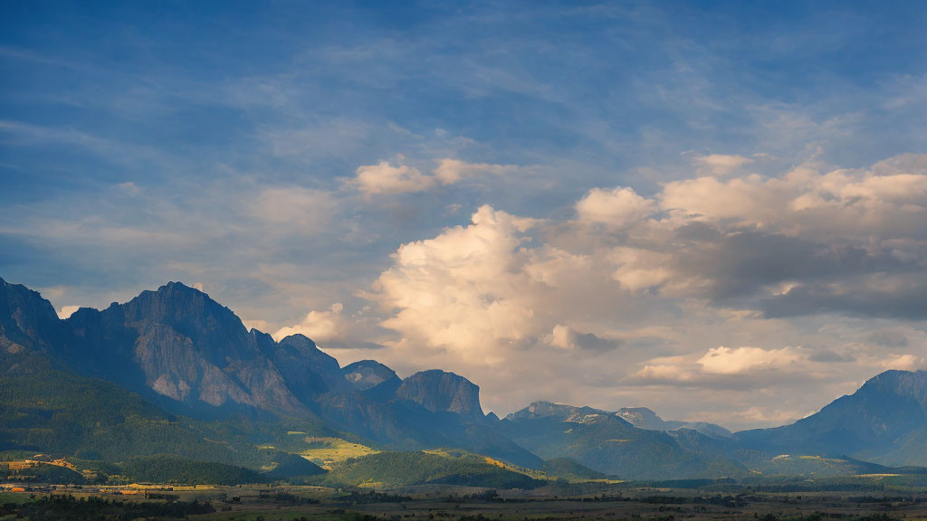 Majestic mountains under dynamic sky with soft sunlight