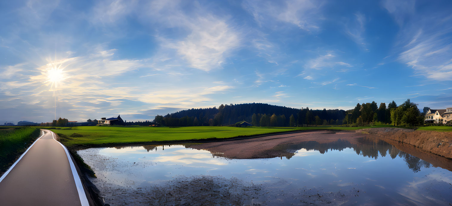 Tranquil landscape with pathway beside water under blue sky