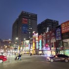 Futuristic cityscape at night with neon lights, flying vehicles, and starry sky