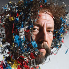 Man's Face Partially Obscured by Colorful Confetti Strands