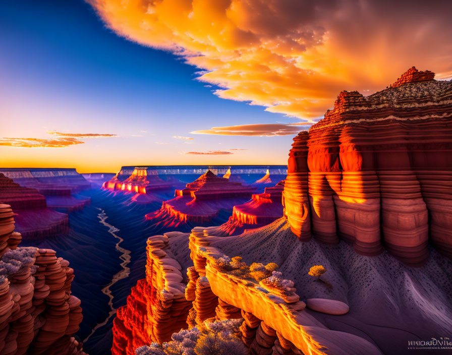 Colorful sunset over layered rock formation and dramatic sky