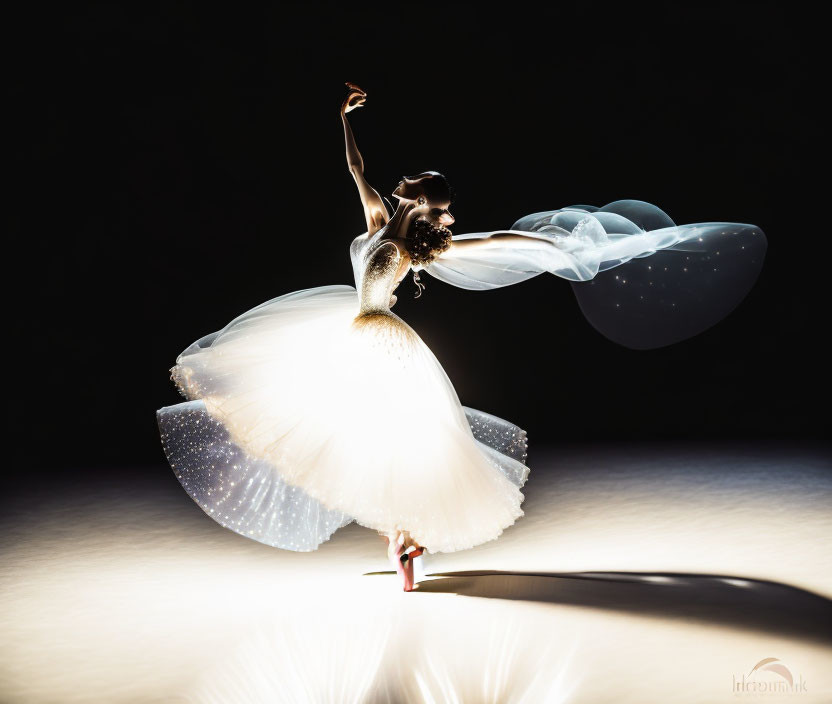 Ballerina in white tutu and blue veil twirling on dark stage