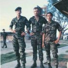 Three young soccer players in matching uniforms on misty field