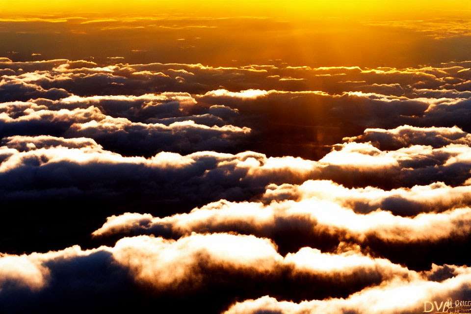 Golden sunlight illuminates dramatic cloudscape in vibrant hues