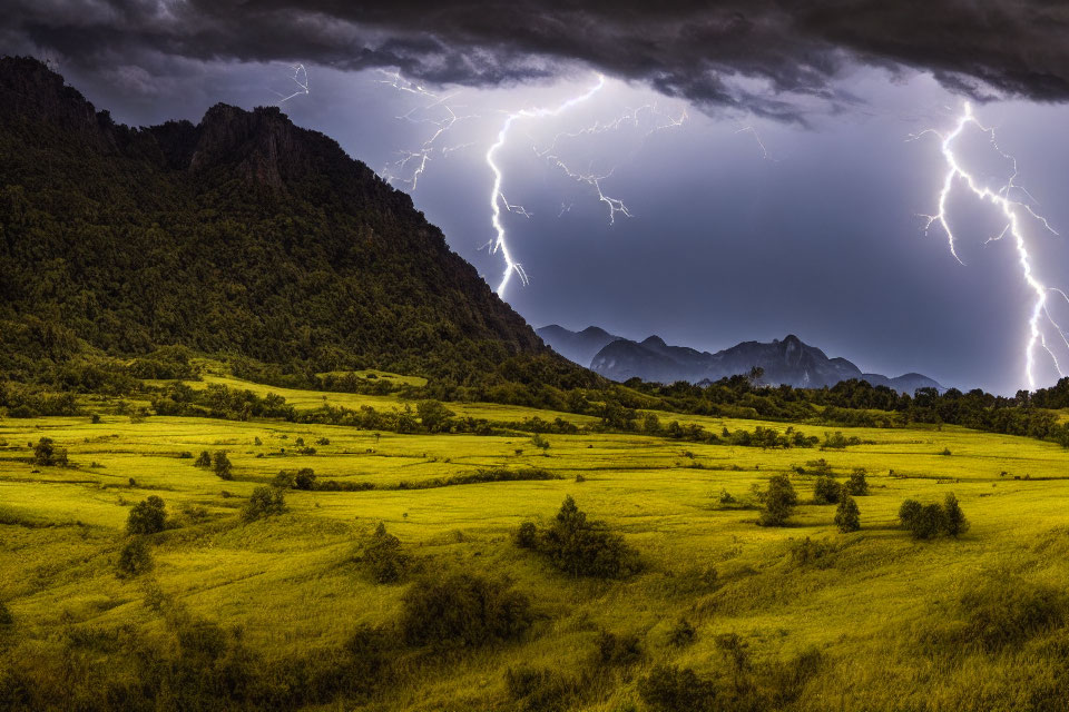 Thunderstorm with Lightning Strikes Over Green Valley and Mountains