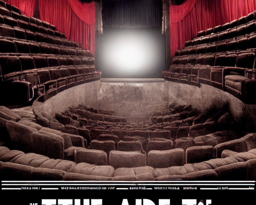 Empty theater with red curtains, black seats, white projection screen