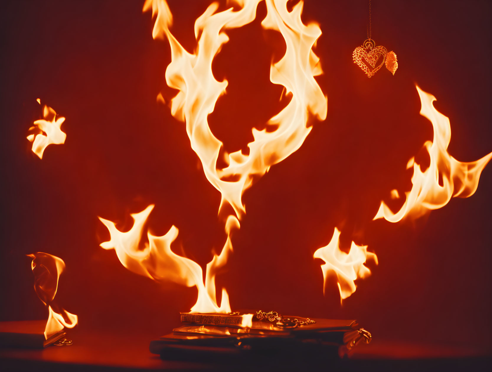 Surreal fiery scene with flaming objects on red backdrop