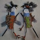 Beaded tribal art figures with elaborate headdresses and colorful attire