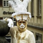 Elaborate Venetian Carnival Costumes with Feathers by Canal