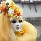 Elaborate Yellow Costume and Mask at Venetian Canal