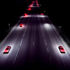 Dark highway at night with glowing red taillights