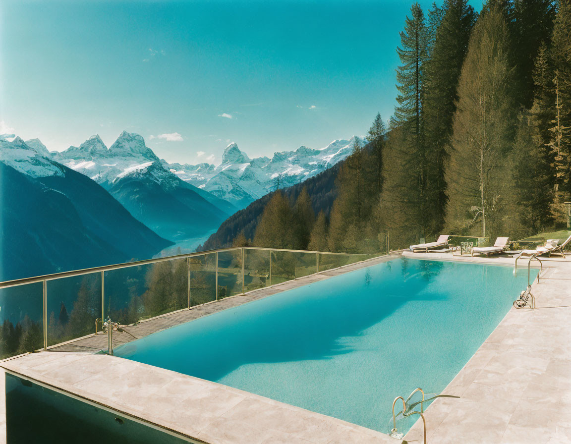 Infinity pool with clear blue water and mountainous landscape view