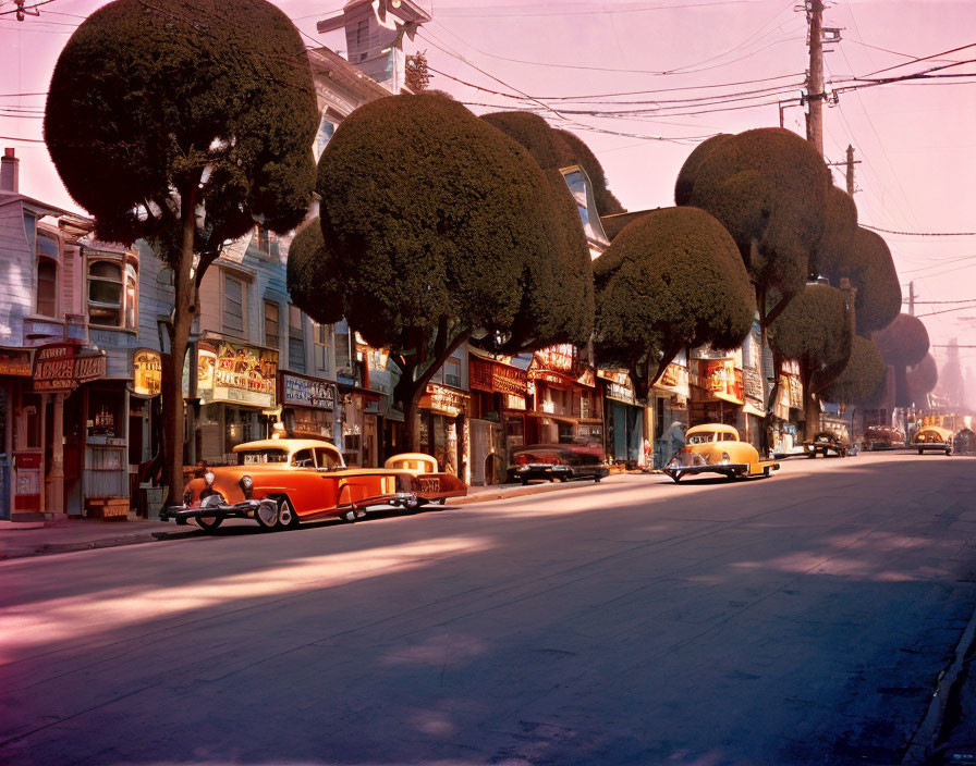 Classic Cars Parked on Vintage Street with Retro Storefronts