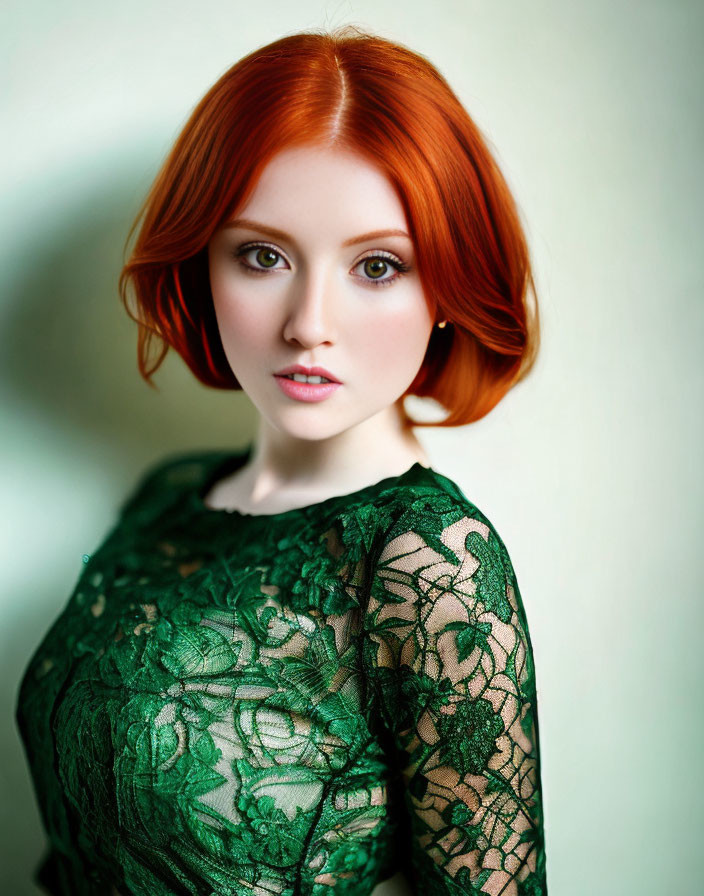 Red-haired woman in green lace dress with fair skin and captivating gaze