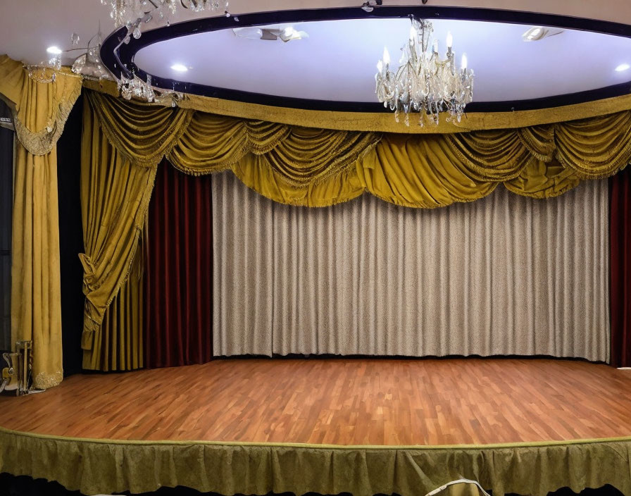 Empty stage with closed curtains, golden drapes, crystal chandelier