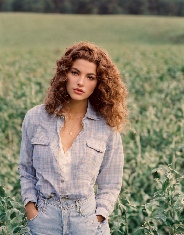 Curly Haired Woman in Blue Plaid Shirt and Jeans in Green Plant Field