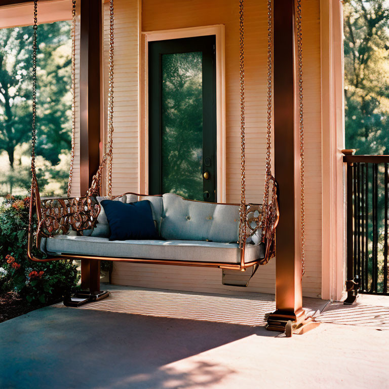 Cushioned Swing Bench on Porch Overlooking Trees