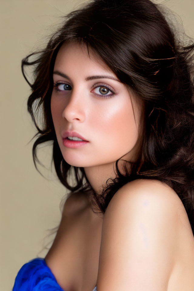 Portrait of Woman with Long Wavy Brown Hair and Blue Draped Shoulders