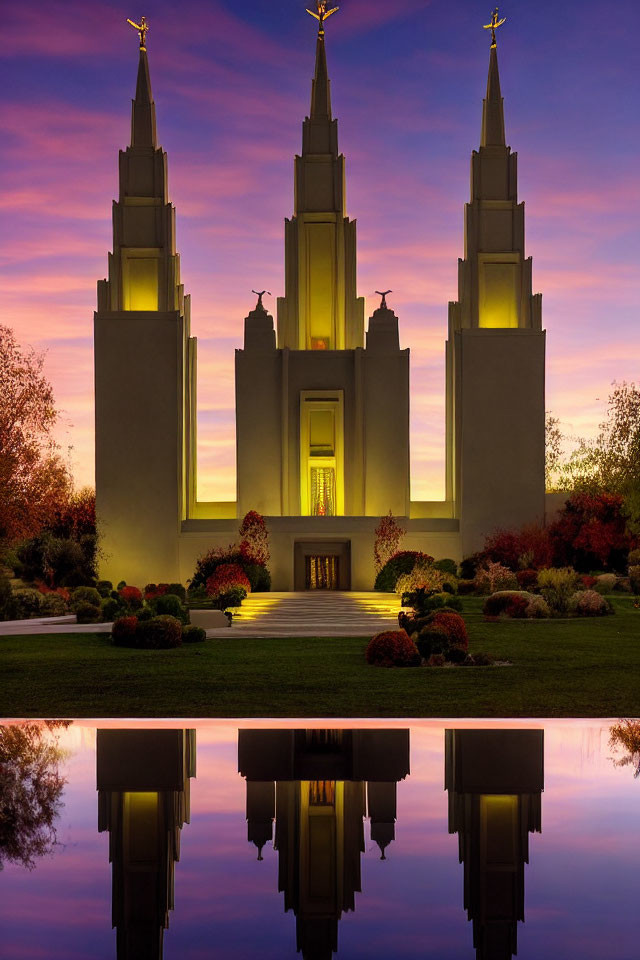 Temple with tall spires at sunset reflected in water