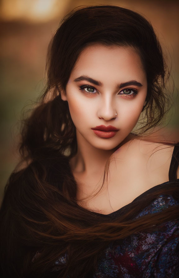 Portrait of woman with dark wavy hair and red lips in colorful blouse