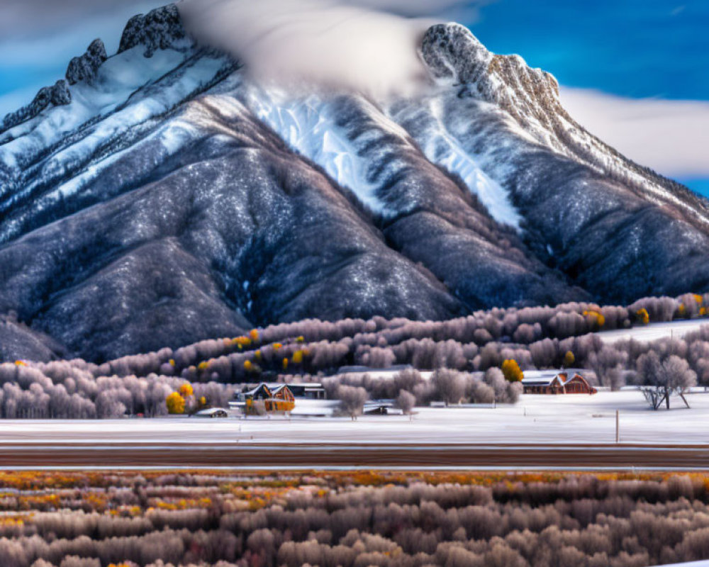 Mountain landscape with autumn trees and buildings under cloudy sky