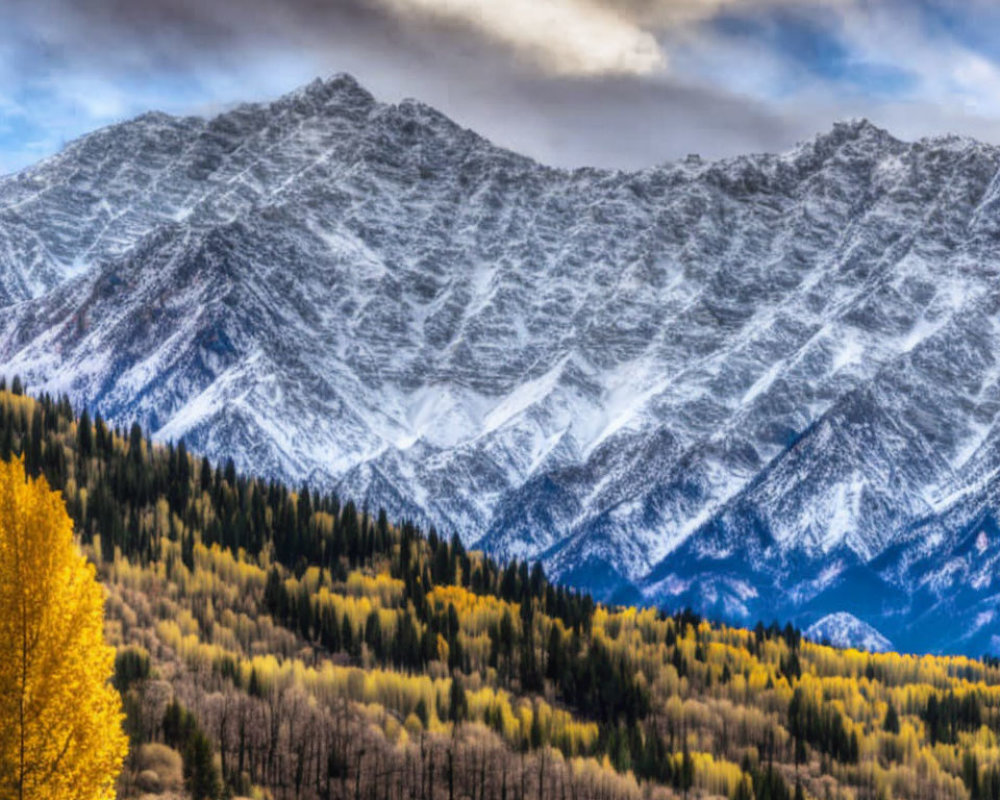 Scenic Snow-Capped Mountain with Autumn Trees and Cloudy Sky